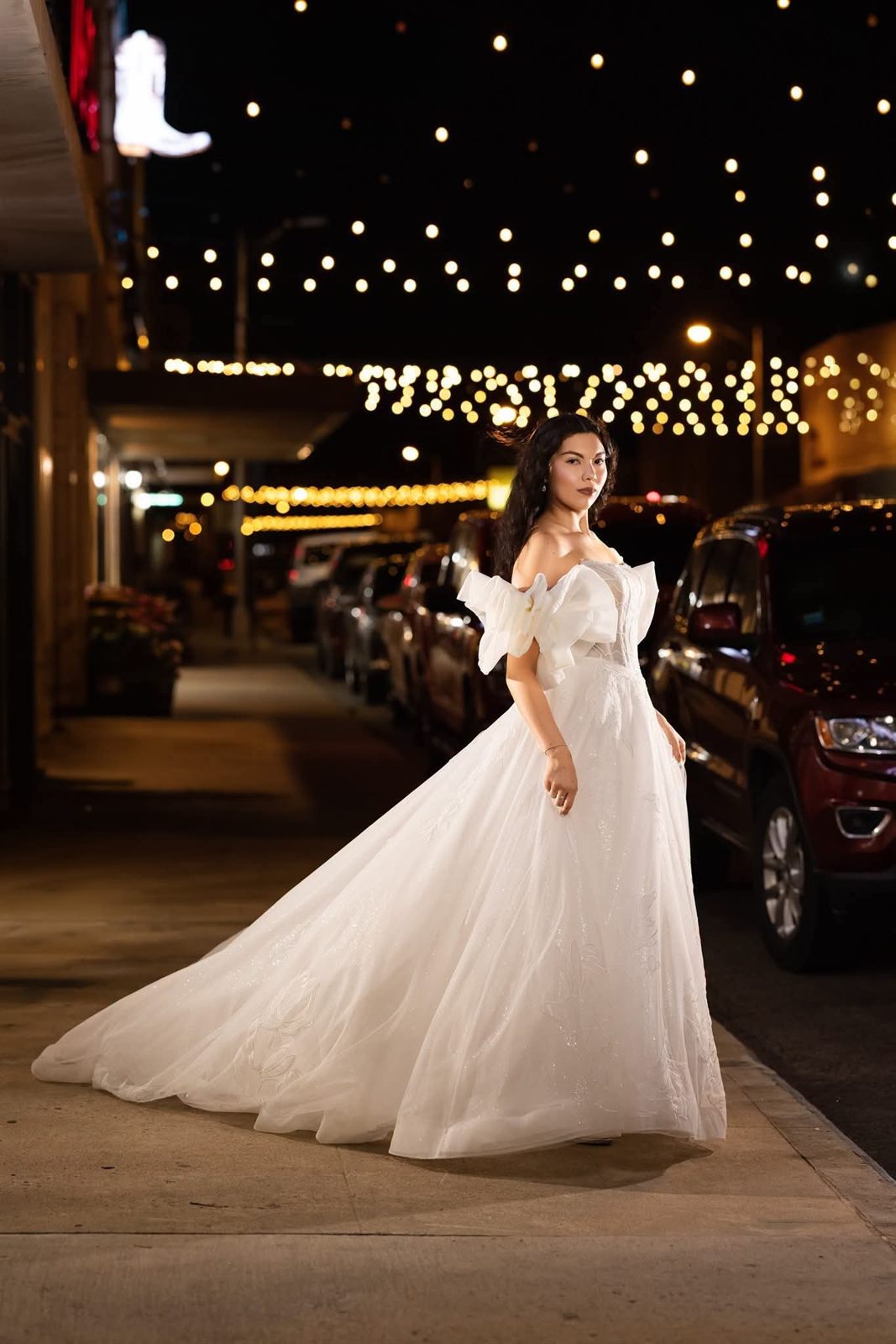 Off-shoulder bridal gown with sculptural bow sleeves on Main Street
