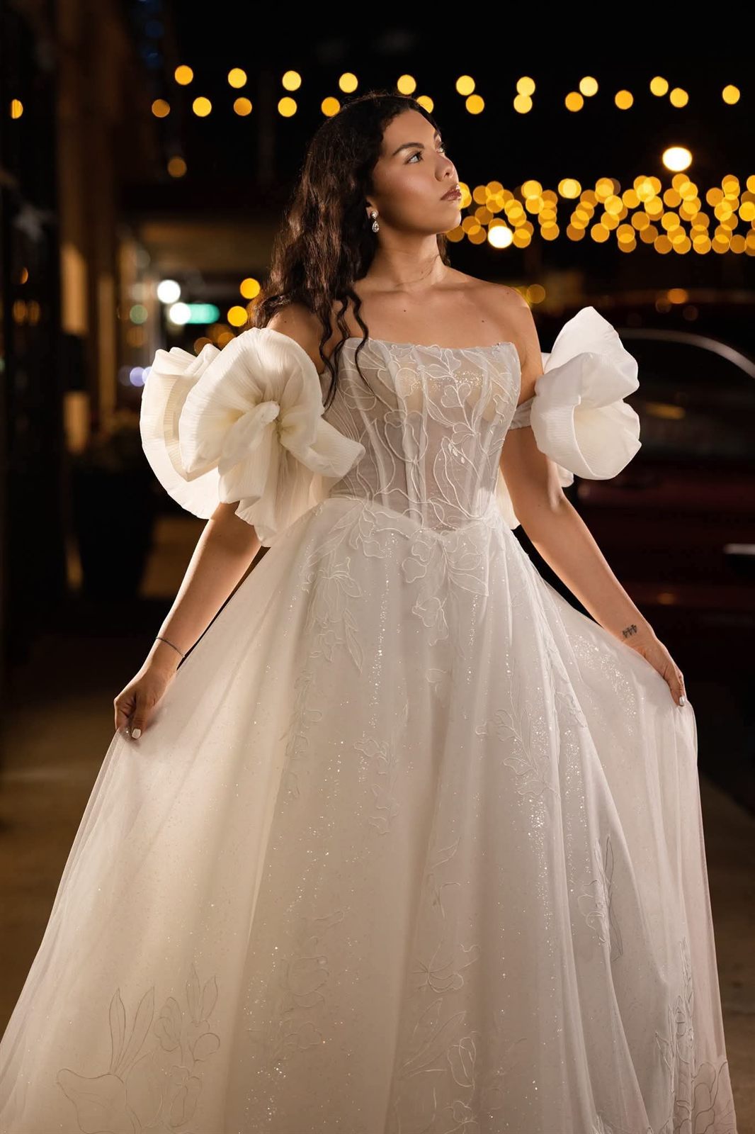 Bridal gown with dramatic sculptural bow sleeves, close detail