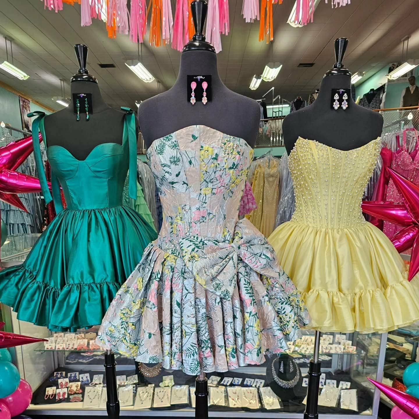 Short homecoming dresses on display in the boutique